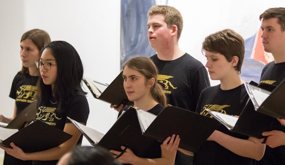 Six Gryphon Singers singing on stage.